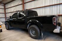Black Pickup in Industrial Warehouse