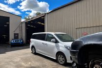 Bright Industrial Warehouse with White Minivan
