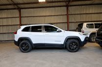 White Jeep Cherokee in Industrial Garage